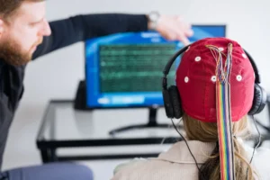 “Child wearing EEG cap and headphones during neurofeedback session with clinician guidance” at the Brain & Body of Norwalk