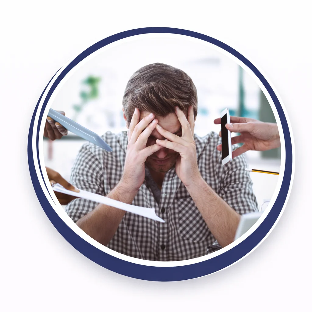 “Overwhelmed man holding head while multiple tasks and devices surround him showing stress and mental overload”